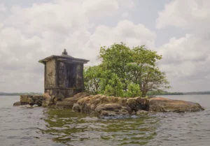 Small boat docking at Five Cent Island (Satha Paha Duwa), the tiny islet in the Madu River, during a Jaliya Boat Safari