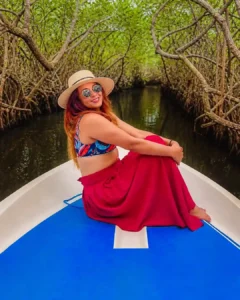 Sri Lankan woman traveling through Madu River mangrove tunnels by boat