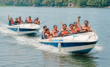Two safari boats with happy travelers cruising along the Madu River