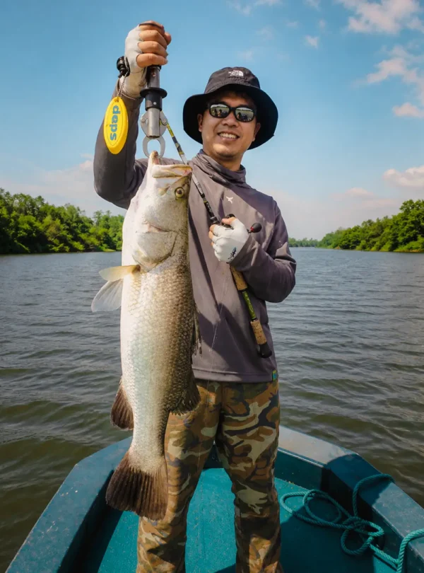 Fishing guest proudly showing a big catch from the Madu River in Sri Lanka