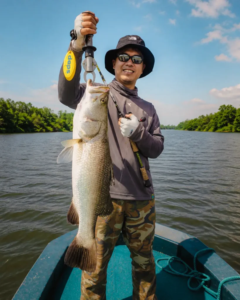 Fishing guest proudly showing a big catch from the Madu River in Sri Lanka