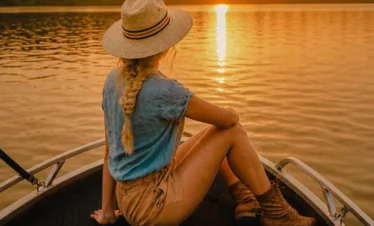 Woman enjoying the sunset during a peaceful Madu River boat safari