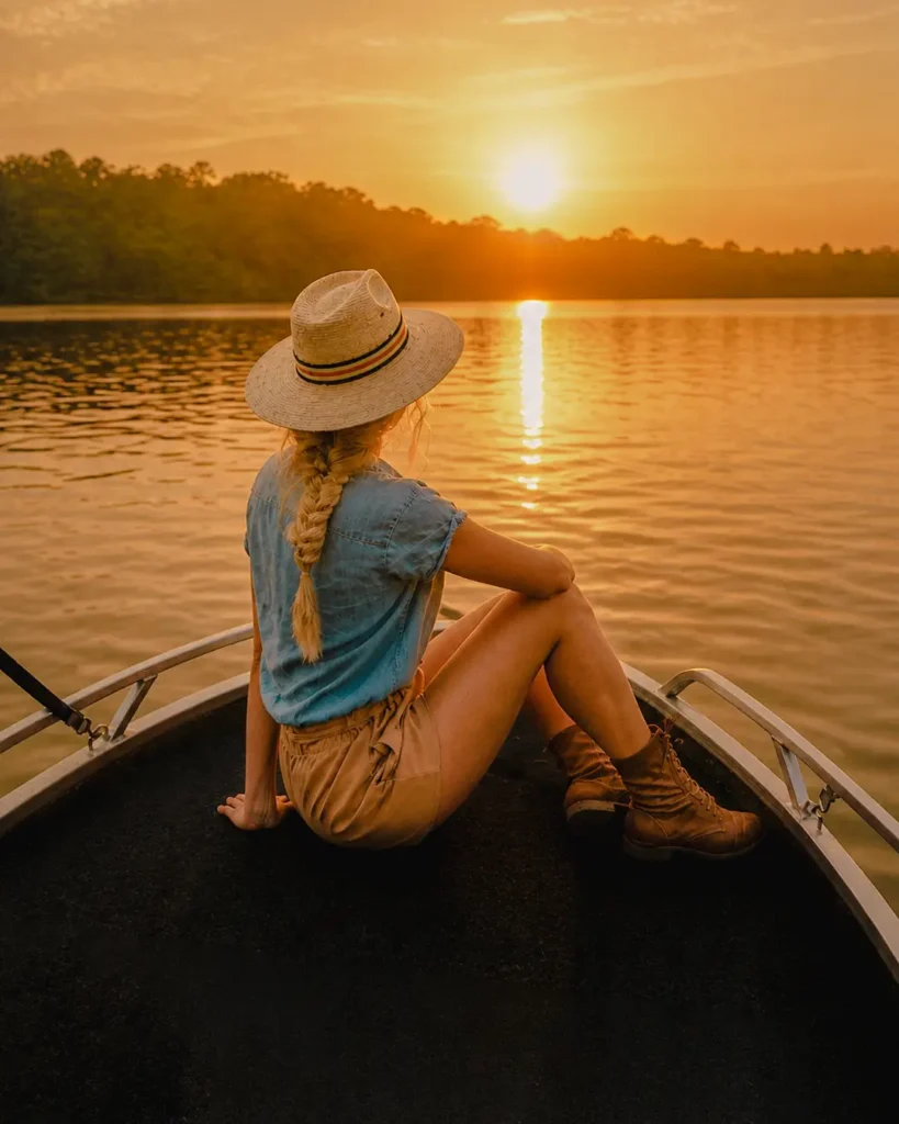 Woman enjoying the sunset during a peaceful Madu River boat safari